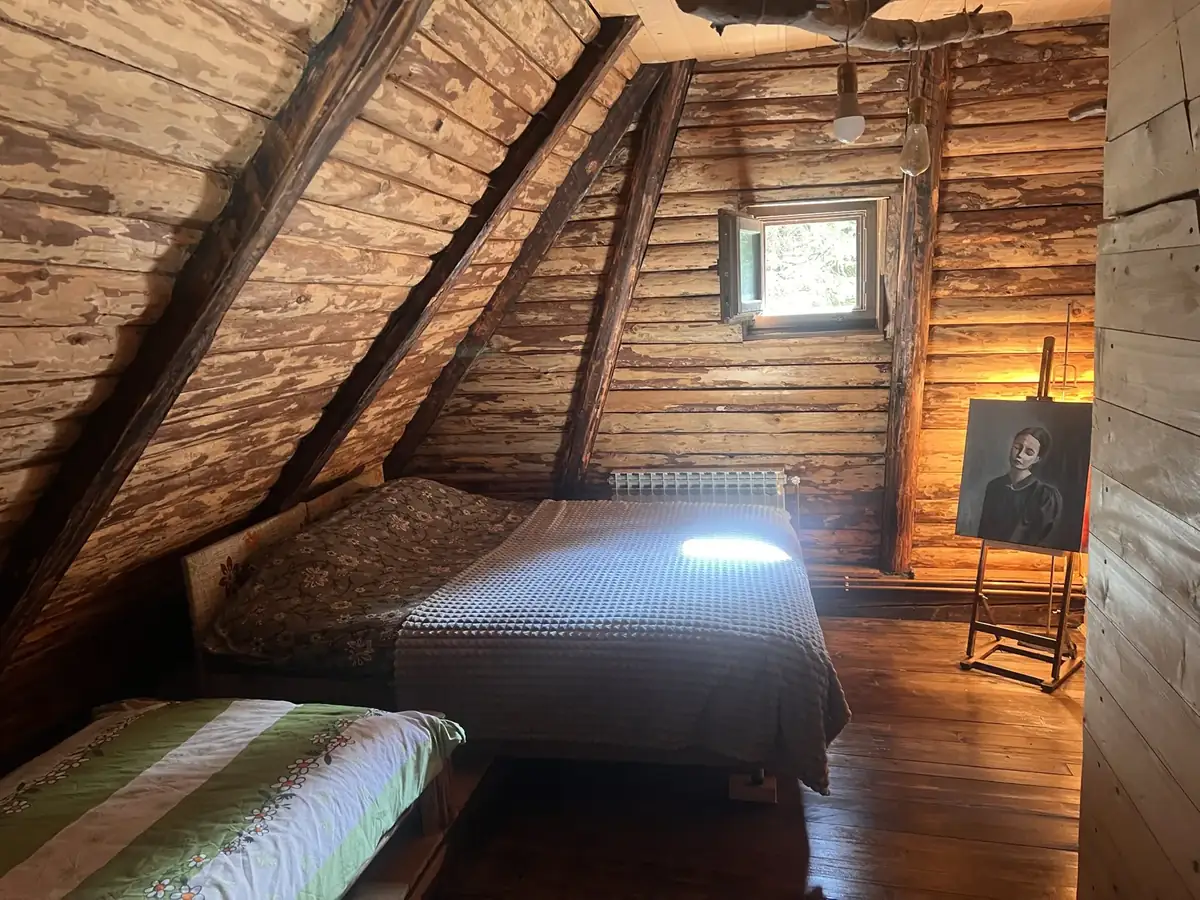 Attic bedroom with a double bed and a small window